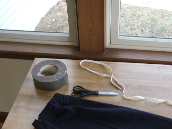 Figure 1. Materials: sweatpants, scissors, shoestring and duct tape.